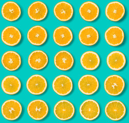 Seamless pattern of orange fruit slices on blue background. Flat lay, top view. Food background. .  Pop art design, creative concept.