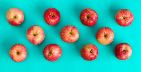 Fruit pattern of red apple on blue background. Flat lay, top view. Pop art design, creative summer concept. Food background.