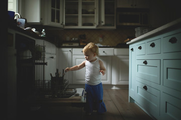 Girl holding kitchen utensils at home