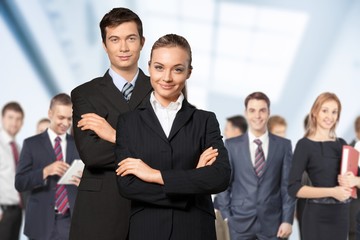 Confident young Business couple with crossed hands on background