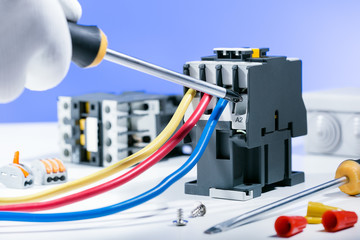 Electrician Working on Electrical Panel. Electrical equipment. Repairing concept.