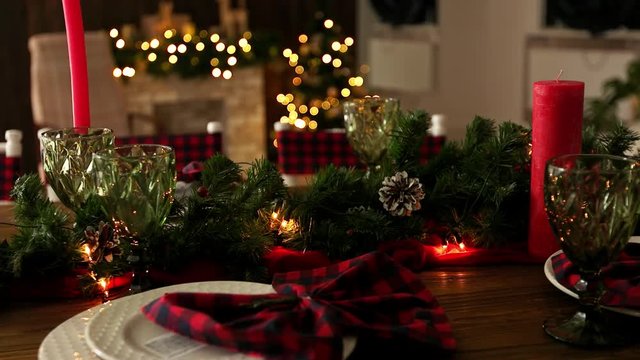 Christmas table. Served dishes. Candles and plates