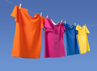 Wash clothes on a rope with clothespins on background