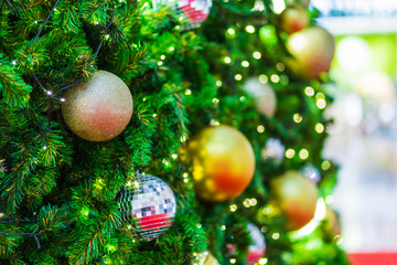 Obraz na płótnie Canvas Closeup of Colorful balls on Green Christmas tree background Decoration During Christmas and New Year.