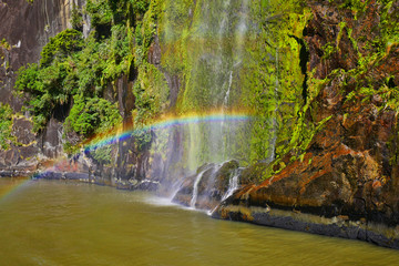 Naklejka premium Rainbow from a cascading waterfall