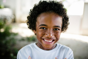 Portrait of smiling boy standing in park