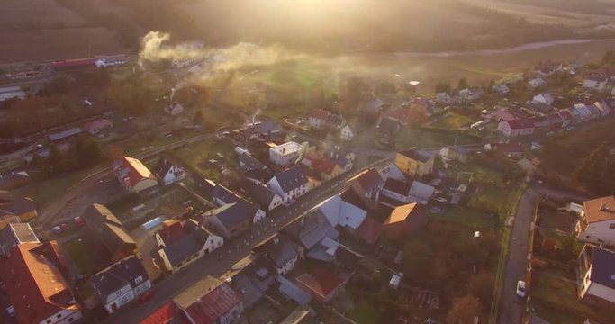Camera flight over a Czech village in winter. Local heating is important source of emissions. Air pollution and climate change theme. Sustainable development and ecology in European Union.