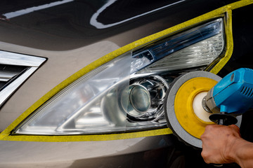 Car headlights with power buffer machine at service station - a series of CAR CARE images.
