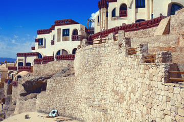 Cottage town on the edge of the cliff. Picturesque natural mountain landscape with nice houses.