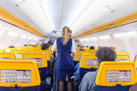 Fototapeta Valencia, Spain - Dec 14, 2017: Interior view of stewardess serving passangers on Ryanair low-cost flight on 14th of December, 2017 on a flight from Trieste to Valencia.