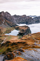 Aerial view over cloud and alpine valley and Trubsee lake of Titlis in Engelberg, Switzerland