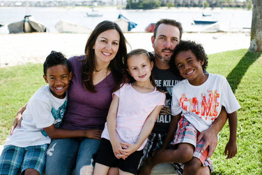 Portrait of happy family sitting on field