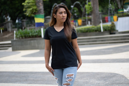 Young woman wearing black v-neck t-shirt posing in outdoor