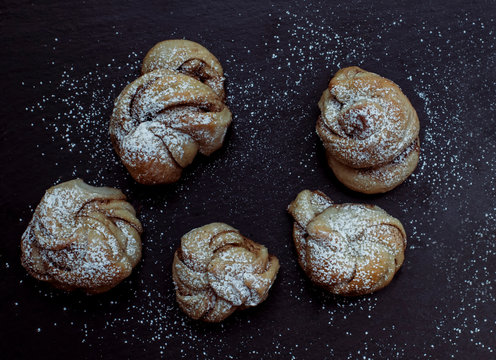 Overhead view of croissants with powdered sugar on table