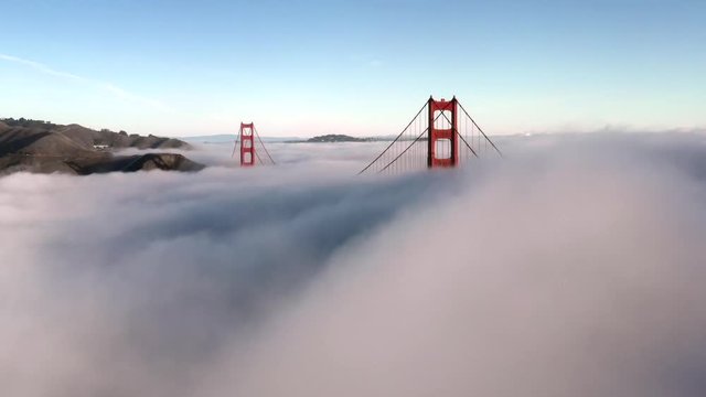 San Francisco Golden Gate Bridge Sticking / Poking Through Thick blanket of Fog - Aerial View / Flyover From Helicopter