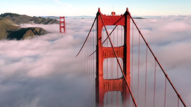 San Francisco Golden Gate Bridge Sticking / Poking Through Thick blanket of Fog - Aerial View / Flyover From Helicopter