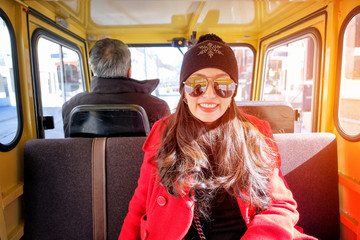 Close up portrait of happy woman sitting in a yellow taxi 