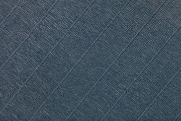Fototapeta premium Textural of dark gray background of wavy corrugated paper, closeup.