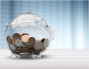 Piggy bank and coins on background