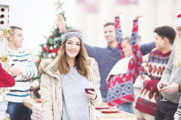 Young woman toasting for Christmas on balkony