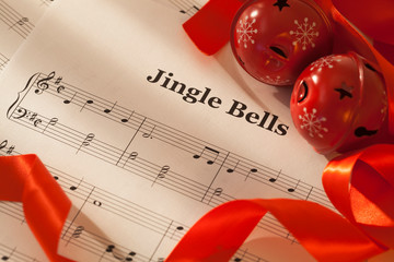 Jingle bells sheet music with red ribbon and jingle bells