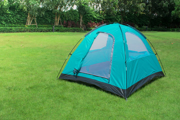 Monodome tent camping on green park and view of trees and sky behind tent