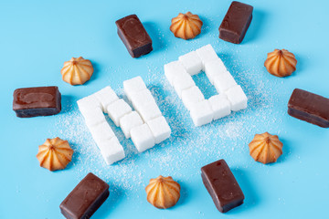 Text No is lined with sugar cubes with sweets and cookies. Harm to the health of sweet and...