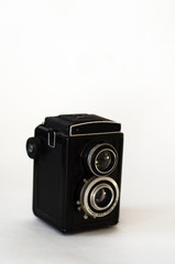 old film camera stands on a white background