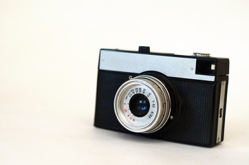old film camera stands on a white background