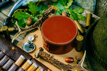 Closeup round leather hunt box for information among hunting or tourist equipment.
