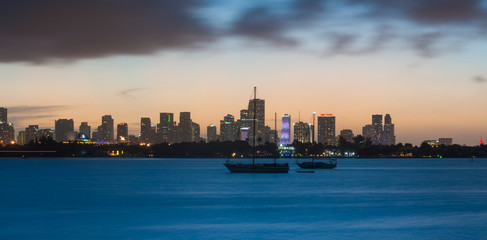 Fototapeta premium Long time exposure of the Miami skyline, with a boat in the foreground, as seen from Miami Beach.