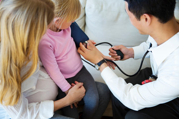 High angle view of doctor examining girl