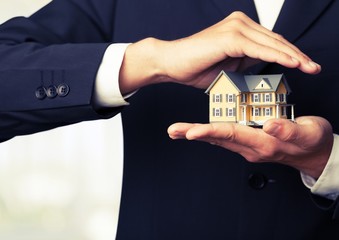 Businessman Holding House Model, Real Estate Concept