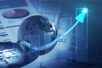 Glass globe with financial reports and graphs, toned image