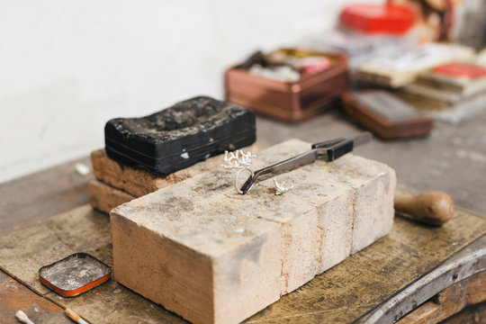 High angle view of ring with hand tools on wooden table in workshop