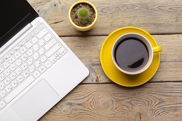 Workplace with office tools and gadgets. Cup of coffee on a table