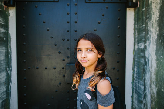 Portrait of brunette girl standing outdoors