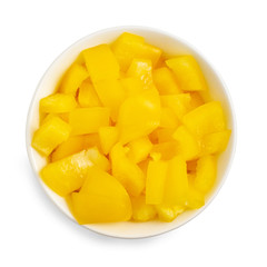 Chopped yellow pepper in bowl isolated on white background. Top view
