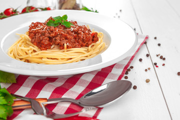 Pasta with meat, tomato sauce and vegetables on the table