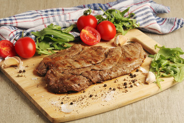 A beef steak well done with vegetables	