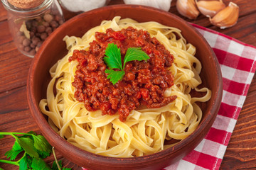 Pasta with meat, tomato sauce and vegetables on the table