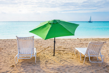 White chairs and umbrella on a beach