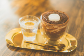 Black coffee or Americano on table with film vintage tone background.