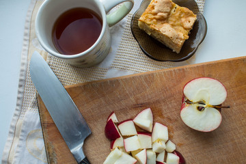 a apple pie knife and tea on a wooden stand