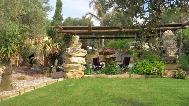 Beautiful garden of luxury resort in Italy with swimming pool