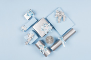 Love background - heart of different decorations, gift boxes, christmas tree in soft pastel blue and silver metallic color, top view.