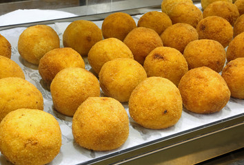 typical fried Sicilian arancini stuffed with mozzarella and toma