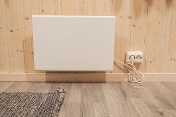 plug-in heater at house wall in winter