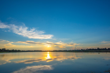 Fototapeta na wymiar Sunset on lake in the summer , Evening sky Landscape Backgrounds