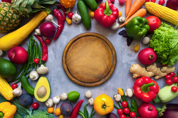 Circle of healthy colorful spicy flavoured seasoning with fresh summer organic antioxidant fruits and vegetables for vegan or vegetarian recipes isolated on grey background. Healthy lifestyle concept